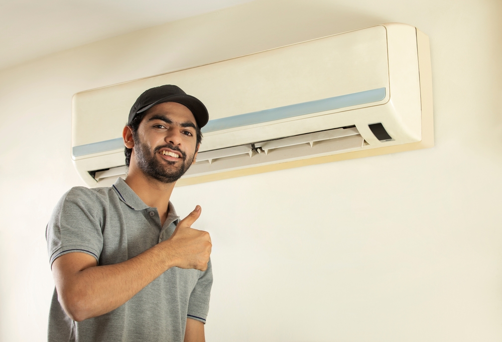 A,Young,Professional,Happily,Smiling,After,Repairing,Air,Conditioner